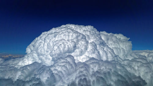 Low angle view of snow against clear blue sky