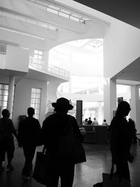 Rear view of silhouette people walking in corridor