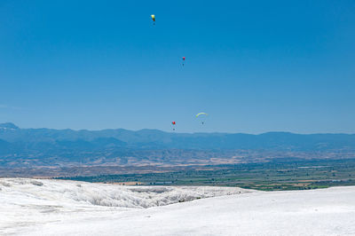 Scenic view of land against blue sky