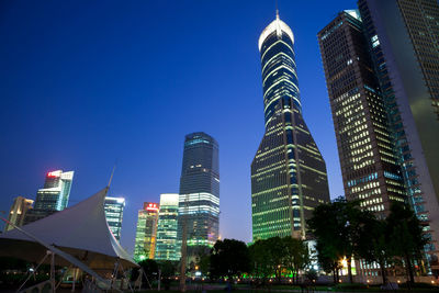 Low angle view of modern buildings against blue sky