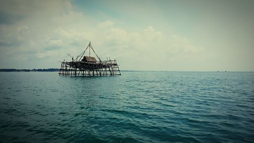 Built structure on sea against sky