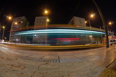 Blurred motion of bus on street in city at night