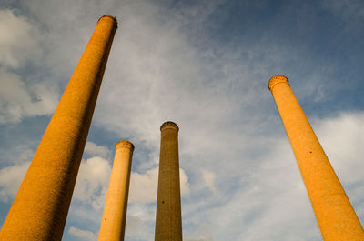 Low angle view of smoke stack against sky