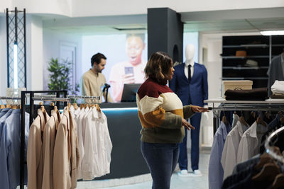 Rear view of woman standing in store