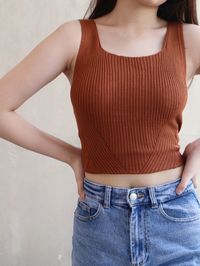 Midsection of woman standing against wall