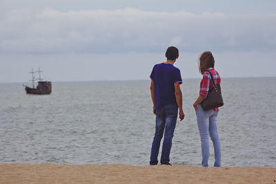 Rear view of man standing on beach