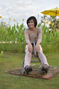 Portrait of teenage girl sitting on field