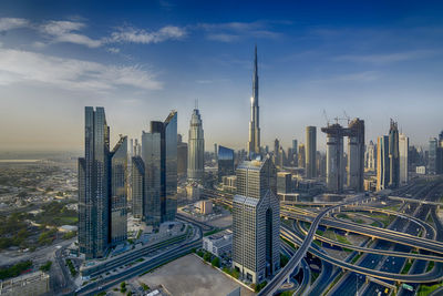 High angle view of modern buildings against cloudy sky