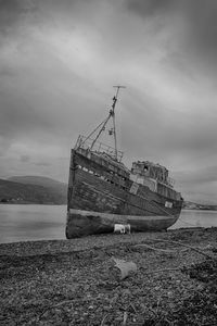 Abandoned boat on shore