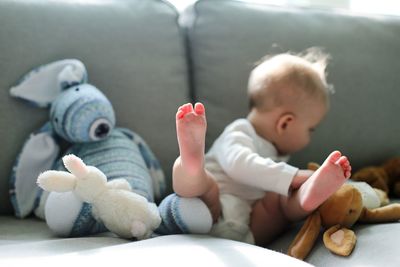 Close-up of baby playing with stuffed toys at home