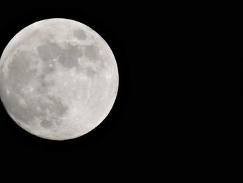 Low angle view of moon against sky at night