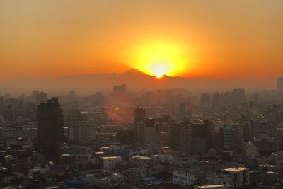 Cityscape against sky during sunset