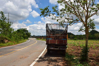 View of empty road against cloudy sky