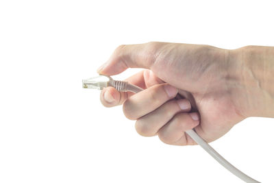 Close-up of hand holding camera over white background