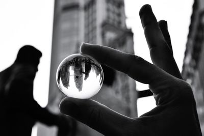 Close-up of hand holding crystal ball