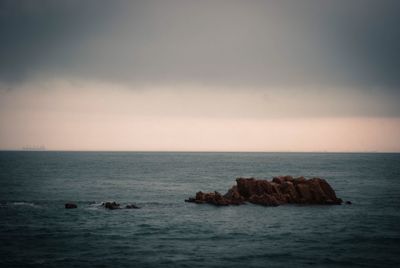 Scenic view of sea against sky at sunset