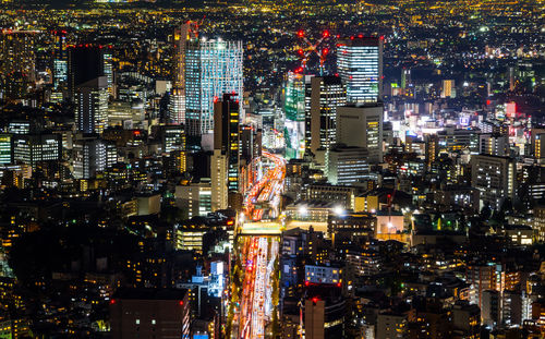 High angle view of illuminated buildings in city at night