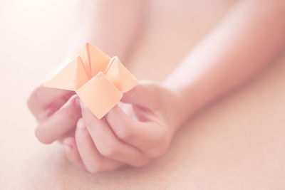 Human hand holding paper design