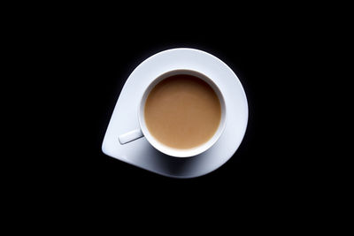 Directly above shot of coffee cup over black background