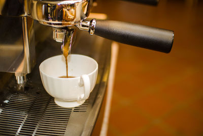 Close-up of coffee emitting from machine