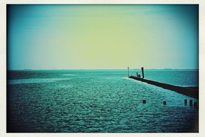 Scenic view of calm sea against clear sky