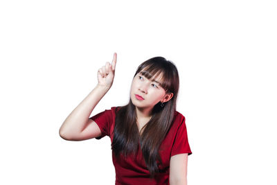 Portrait of beautiful young woman against white background