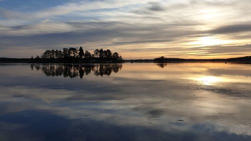 Scenic view of lake against sky during sunset