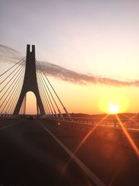 View of suspension bridge against sky during sunset