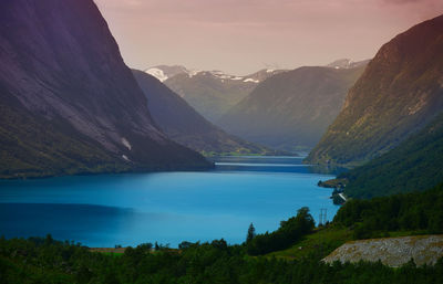 Scenic view of lake and mountains against sky