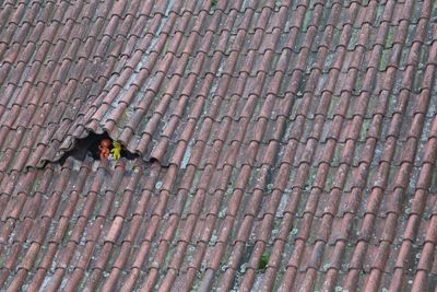 High angle view of people walking on roof tiles