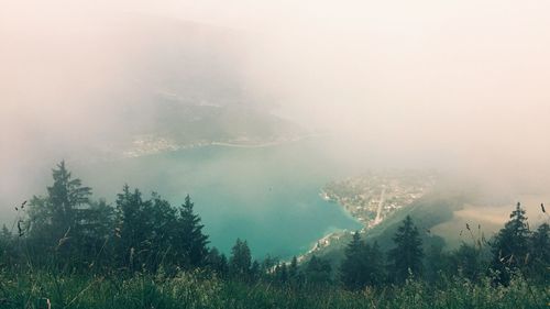 Scenic view of trees and mountains during foggy weather