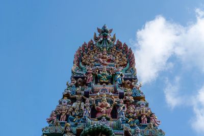 Low angle view of statue  against sky.  sri mariamman temple, singapore 