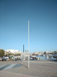 Street by building against clear blue sky