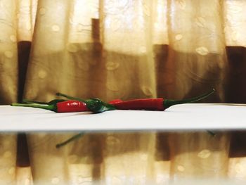 Close-up of red chili pepper on table