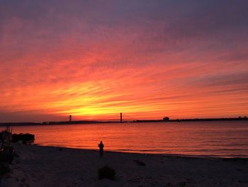 Silhouette of man on beach during sunset