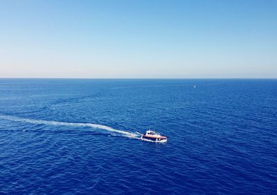 High angle view of boat sailing in sea against clear sky