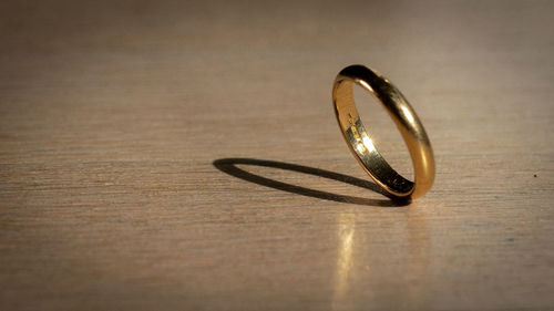 Close-up of wedding rings on table