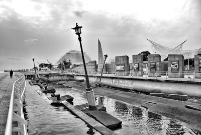 View of harbor against cloudy sky