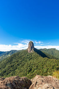 Scenic view of mountain against blue sky