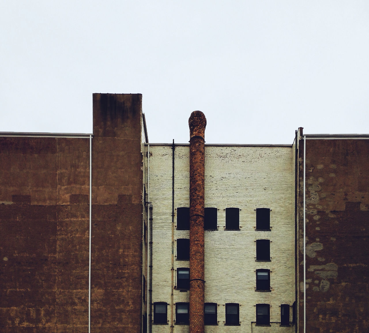 architecture, built structure, building exterior, clear sky, low angle view, window, copy space, building, old, brick wall, wall - building feature, residential structure, house, exterior, day, abandoned, residential building, outdoors, no people, weathered