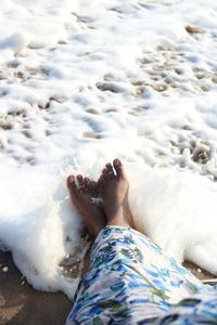 Low section of person lying in water