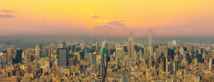 Aerial view of cityscape against sky during sunset