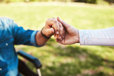 Close-up of couple holding hands