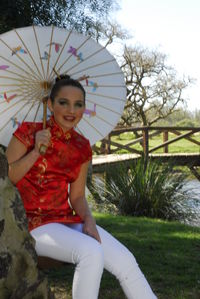 Portrait of a smiling young woman sitting outdoors