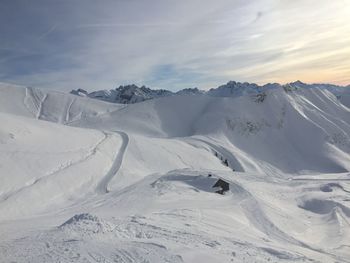 Scenic view of snow covered mountains against sky