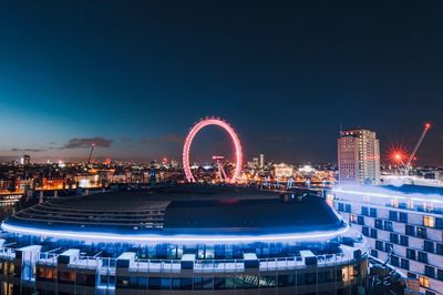 Illuminated ferris wheel at night