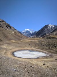 Scenic view of mountains against clear blue sky