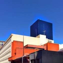 Low angle view of buildings against clear blue sky