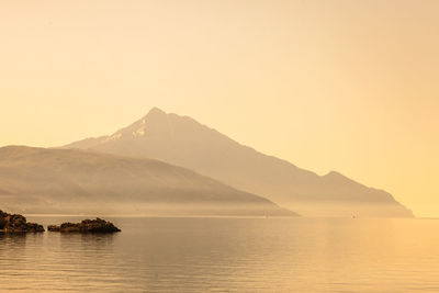 Scenic view of lake and mountains against clear sky