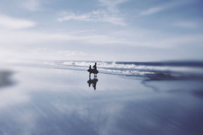 People on beach against sky